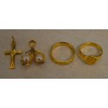 Tested as between 18ct and 22ct gold lot comprising of 2 Oriental rings, a cross and a pendant,