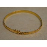 Tested as between 18ct and 22ct gold Oriental gold bangle, approx weight 8.