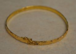Tested as between 18ct and 22ct gold Oriental gold bangle, approx weight 8.