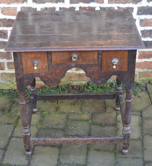 Small oak Georgian lowboy with cross banding to the drawers on turned legs H 71cm W67cm D53cm.