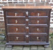 Early 18th century oak chest of drawers with 5 moulded drawers, brass drop handles on bun feet,