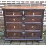 Early 18th century oak chest of drawers with 5 moulded drawers, brass drop handles on bun feet,