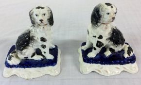 Pair of black & white Staffordshire dogs on blue cushions H 10 cm L 9 cm