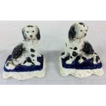 Pair of black & white Staffordshire dogs on blue cushions H 10 cm L 9 cm