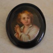 Whitby jet brooch depicting a child