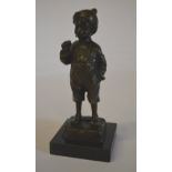 Bronze figure of a young boy smoking,