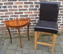 Tall faux leather chair and a demi lune table