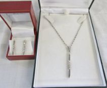 Pair of silver drop earrings with matching silver necklace and pendant