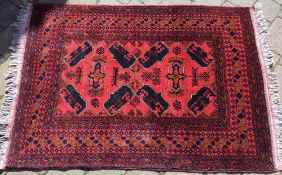 Persian style red ground rug 158cm by 104cm