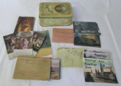 Tin containing German and Bamforth postcards