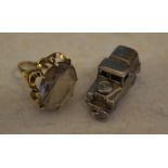 9ct gold dress ring and a silver charm in the shape of a Land Rover