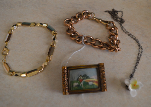 2 yellow metal bracelets,