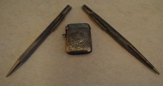 2 silver propelling pencils and a silver vesta case, total approx weight 1.