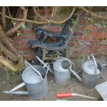 3 galvanized watering cans and a two pairs of garden bench ends