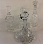 4 glass decanters (one with wrong stopper) & a silver plate Scotch label