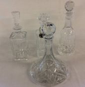 4 glass decanters (one with wrong stopper) & a silver plate Scotch label