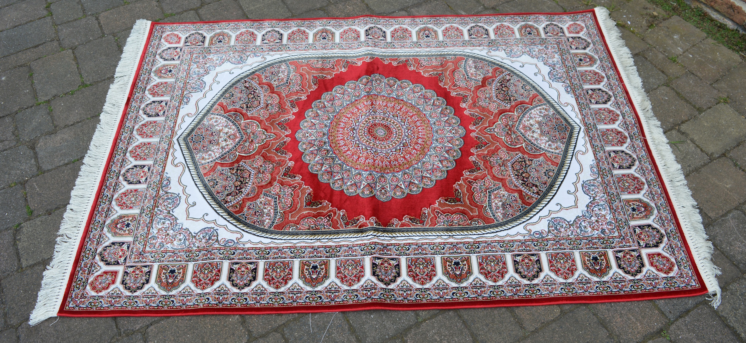 Red ground woven silk rug with a unique medallion design,
