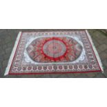 Red ground woven silk rug with a unique medallion design,