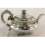 George IV silver squat form tea pot with gadrooned borders & acanthus leaf decoration to spout.