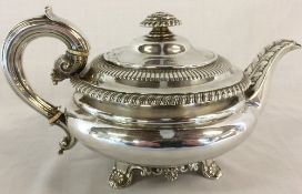 George IV silver squat form tea pot with gadrooned borders & acanthus leaf decoration to spout.