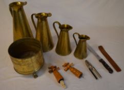 Graduated hammered brass jugs,