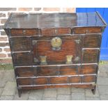 Oriental cabinet with 3 drawers over cupboard with ring handles,