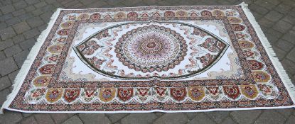 Ivory ground woven silk rug with a Shabaz medallion design,