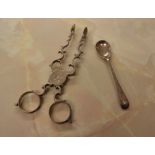 Silver sugar nips and a small silver condiment spoon, approx total weight 1.