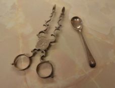 Silver sugar nips and a small silver condiment spoon, approx total weight 1.