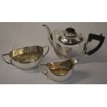 Silver tea set comprising of teapot, sugar bowl and milk jug with part gadrooned body,