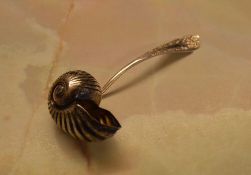 An unusual silver plated sugar sifter spoon formed as a Nautilus shell,