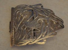 Silver half belt buckle depicting a flamingo,