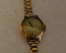 9ct gold ladies wristwatch (body only) on a rolled gold strap