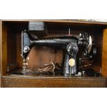 Cased Singer electric sewing machine