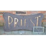 Cast iron 'Priest' sign together with an old cast iron drain cover