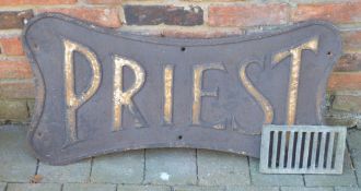 Cast iron 'Priest' sign together with an old cast iron drain cover