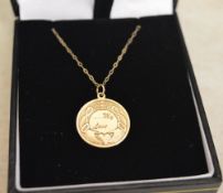 Yellow metal disc pendant with engraving on a chain marked 9k, total approx weight 2.