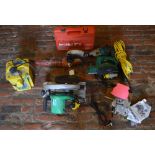 Various power tools including a Makita hammer drill, Hitachi circular saw,