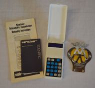 Sinclair Scientific calculator with instructions and an AA car badge