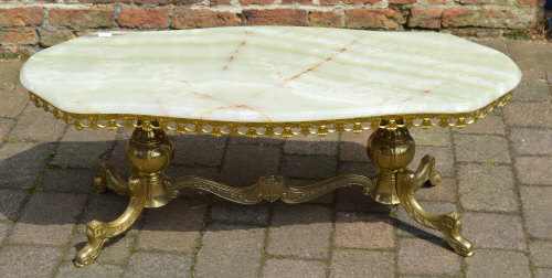 An ornate brass based Onyx top coffee table