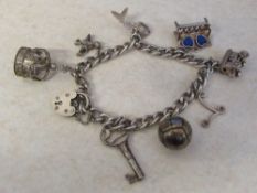 Silver gate bracelet Birmingham 1972 with white metal charms total weight 1.