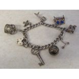Silver gate bracelet Birmingham 1972 with white metal charms total weight 1.