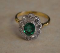 18ct gold emerald and diamond daisy ring,