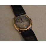 9ct gold body wristwatch on leather strap with engraving to rear of case,