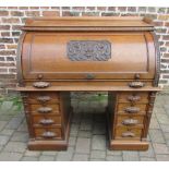 An unusual late 19th century oak barrel top desk with deep carving & gallery top