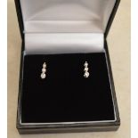 Pair of 18ct white gold diamond 3 stone drop earrings with 9ct white gold butterflies