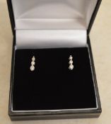 Pair of 18ct white gold diamond 3 stone drop earrings with 9ct white gold butterflies