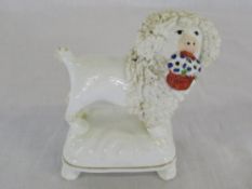 Staffordshire style porcelain poodle with basket