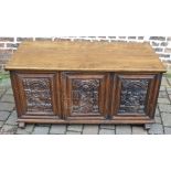 An oak coffer made from 17th century carved continental panels with a modern lid