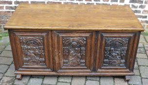 An oak coffer made from 17th century carved continental panels with a modern lid